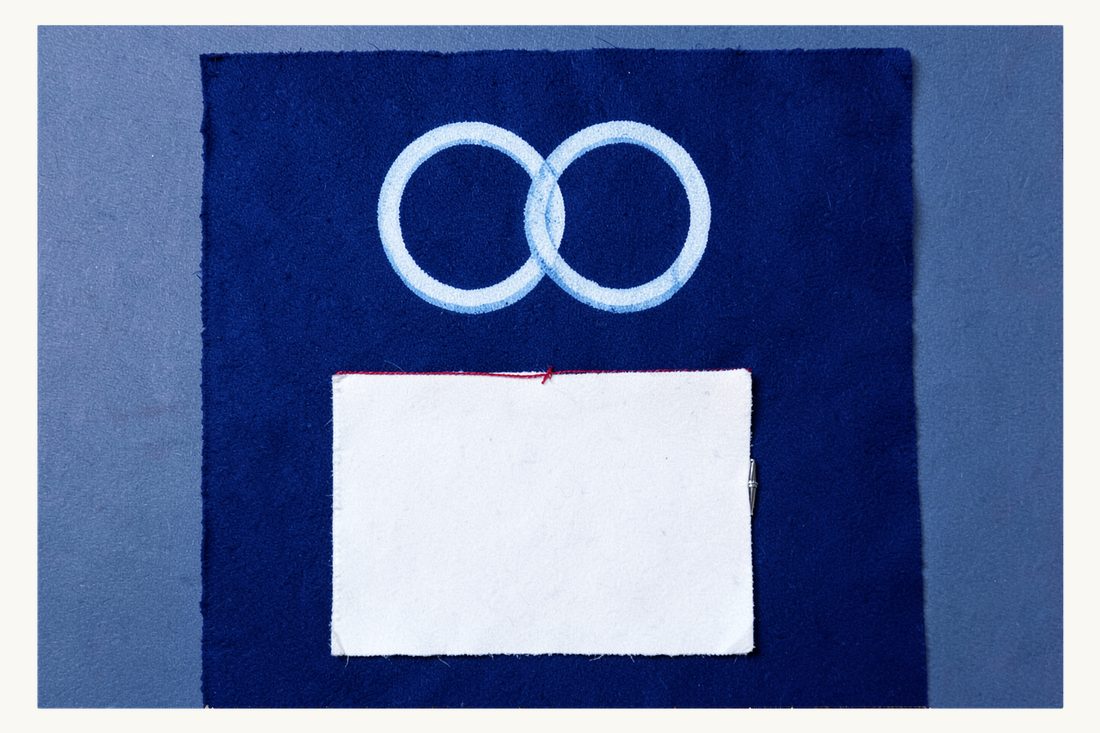 Prenuptial agreement for foreign couples in Turkey: two interlocked wedding rings joined by a red thread to a blank sheet with a fountain pen, cyanotype print