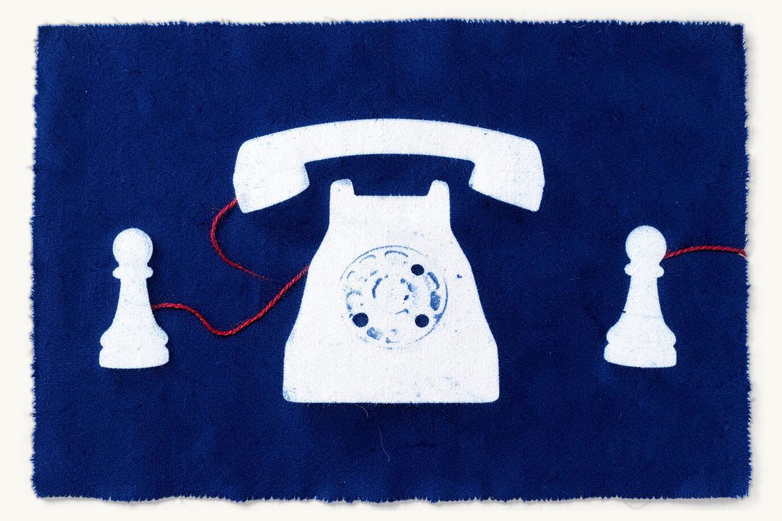 Sending money, letters and calls to an inmate in Türkiye: a large plain telephone at the centre, a red curling cord joining it to a chess pawn on each side
