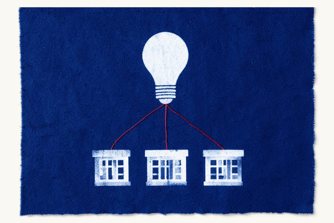 Franchise agreements as vertical agreements: a large lightbulb at the top joined by a red thread splitting into three lines to a row of three identical small office blocks, cyanotype print